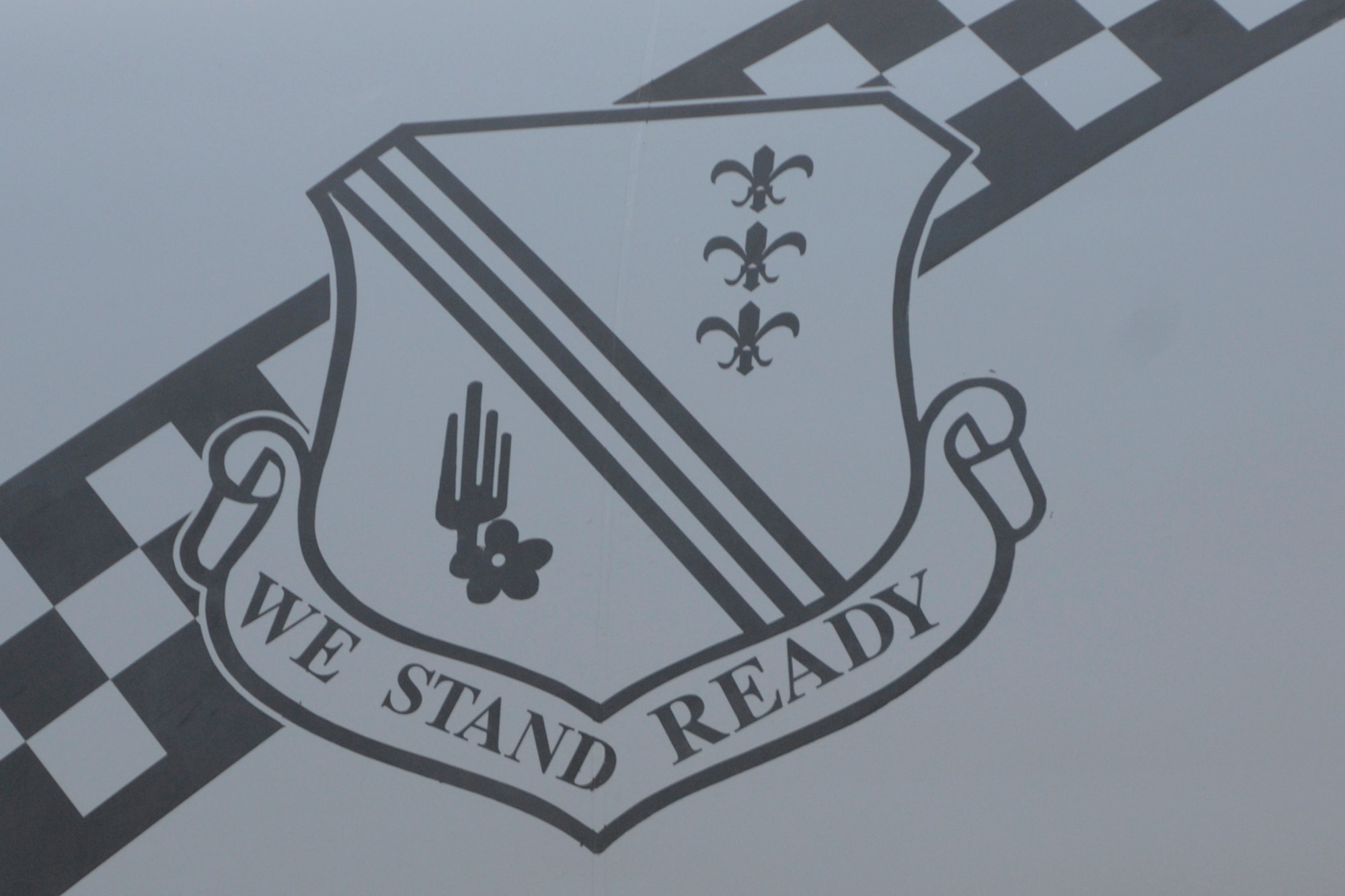The 127th Wing crest rests on a checkerboard stripe on a KC-135 Stratotanker at Selfridge Air National Guard Base. The checkerboard salutes the heritage of the 171st and 191st squadrons at Selfridge, which have been using the checkerboard design, often seen in black and yellow, since at least 1972. (Air National Guard photo by Brittani Baisden)