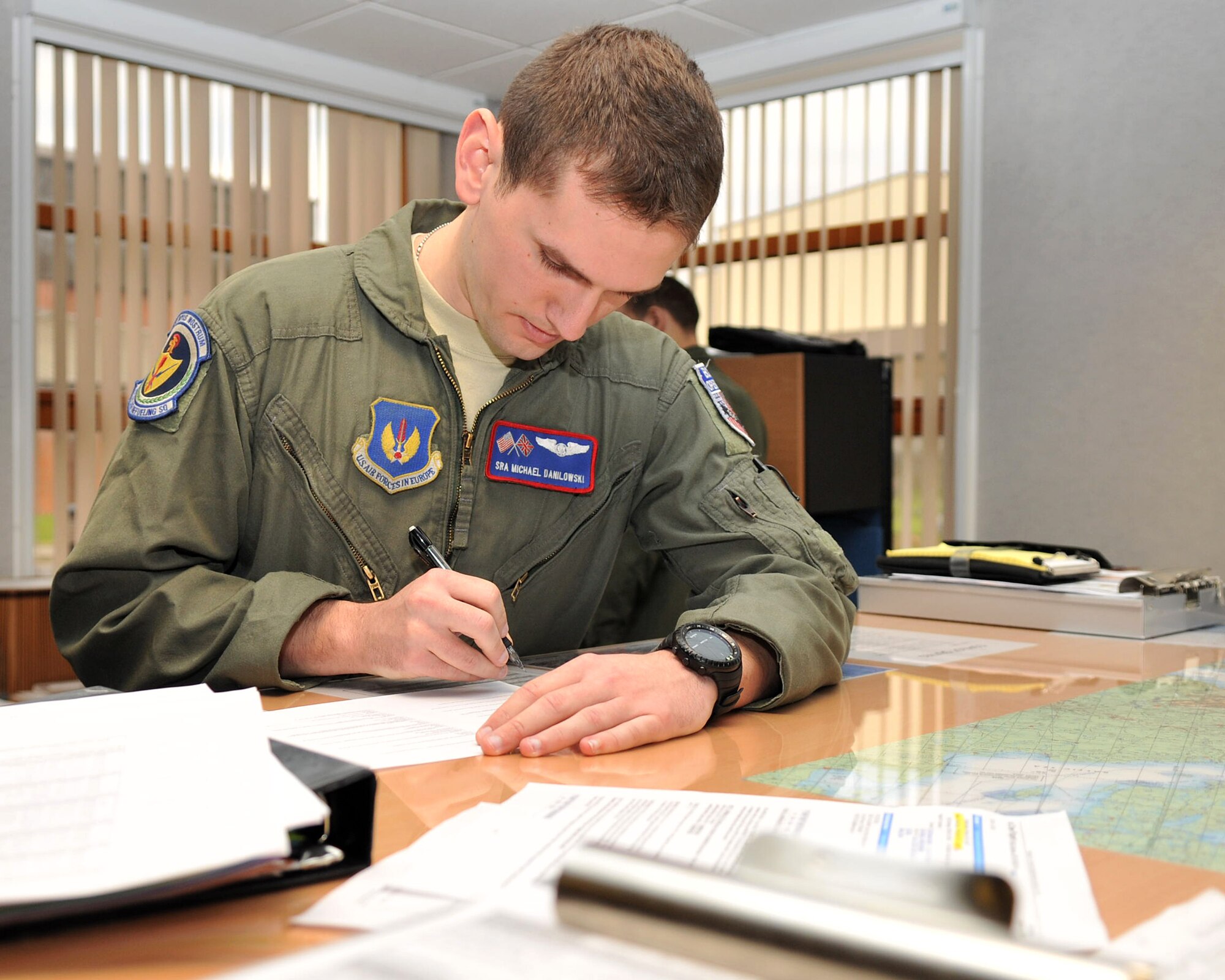 Senior Airman Michael Danilowski,  351st Air Refueling Squadron NCO in charge of safety and boom operator instructor, fills out paperwork prior to a flight Nov. 14, 2012, at RAF Mildenhall, England. (U.S. Air Force photo by Senior Airman Jerilyn Quintanilla/Released) 