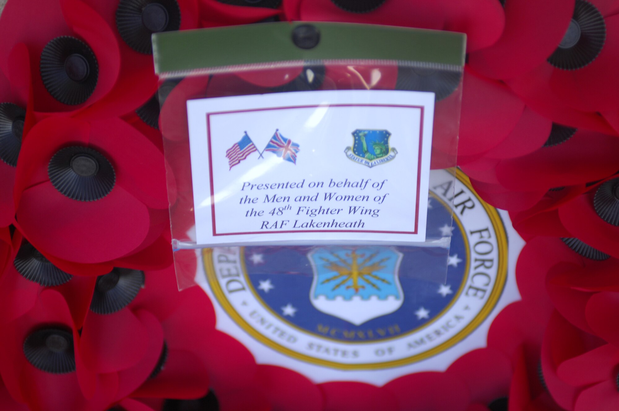 MARTLESHAM HEATH, England - A poppy wreath sits at the bottom of a memorial after being placed there during a Remembrance Day ceremony Nov. 11, 2012. More than 200 people attended the ceremony, which was hosted by the Martlesham Heath Aviation Society and supported by the 48th Fighter Wing. American Airmen served in the 356th Fighter Group, a United States Army Air Forces unit, which was stationed at Royal Air Force Station Martlesham Heath during World War II. (U.S. Air Force photo by Staff Sgt. Stephen Linch)

