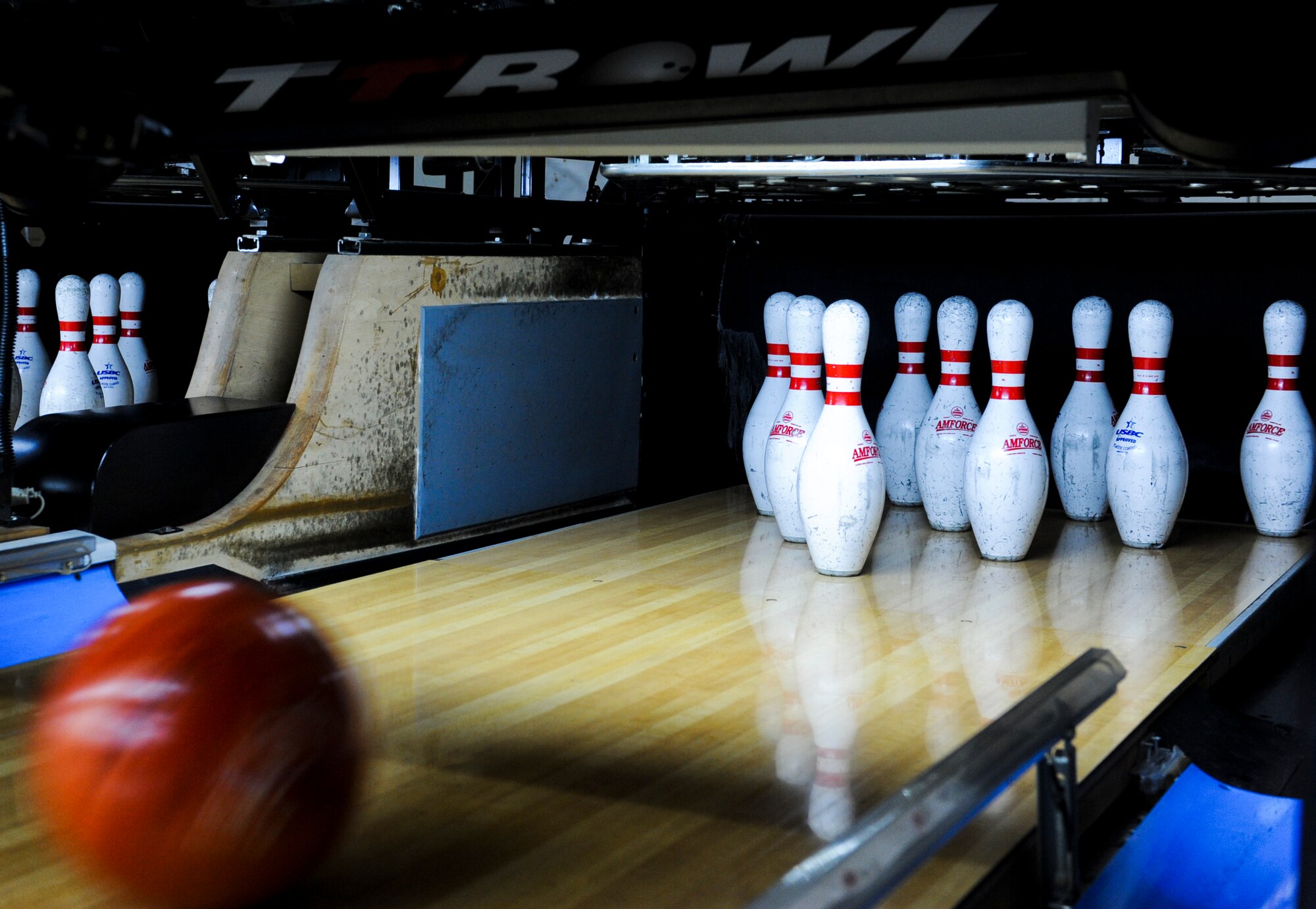 A bowling ball rolled by an athlete knocks over pins during the Kadena Special Olympics Bowling event at Mihama, Okinawa, Nov. 10, 2012. The KSO will be held on Kadena Nov. 17 with more than 300 athletes, volunteers and interpreters expected to attend. This event was one of many events leading up to the 13th annual KSO. (U.S. Air Force Photo/Airman 1st Class Justin Veazie) 