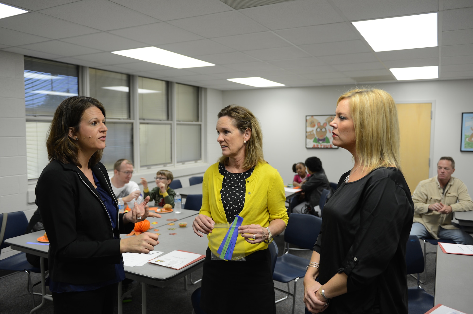(From left) Dr. Melissa Morris, Shaw Heights Elementary School principal, speaks to Victoria Bailey, local trophy and engraving shop owner and Pam Caine, spouse of Col. Scott Caine, 9th Air Force vice commander about the student, parent workshop held in the school’s multi-purpose room at Shaw Air Force Base, S.C., Nov 13, 2012. As part of the Principal for a Day program, designed to strengthen community ties and academic awareness, Bailey and Caine followed principal Morris throughout the school observing her daily roles as principal. (U.S. Air Force photo by Airman 1st Class Daniel Blackwell/Released)