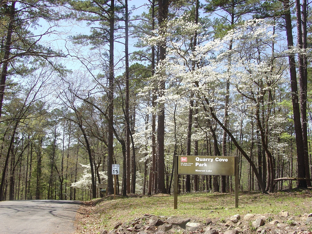 Entrance into Quarry Cove Park with dogwood trees in bloom.