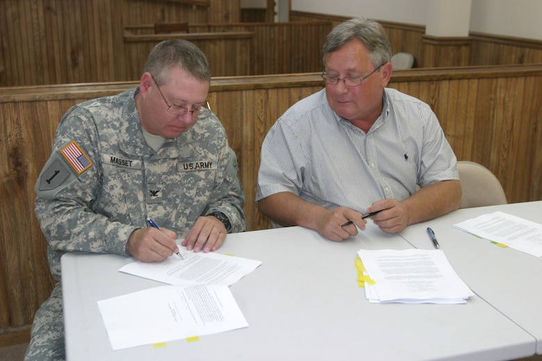 Little Rock District Commander Col. Glen Masset and Augusta Mayor Rocky Tidwell sign a Project Partnership Agreement to proceed with a streambank protection project. Heavy rains in the spring of 2008 and 2009 caused serious bank erosion along the White River near Augusta’s downtown area.
