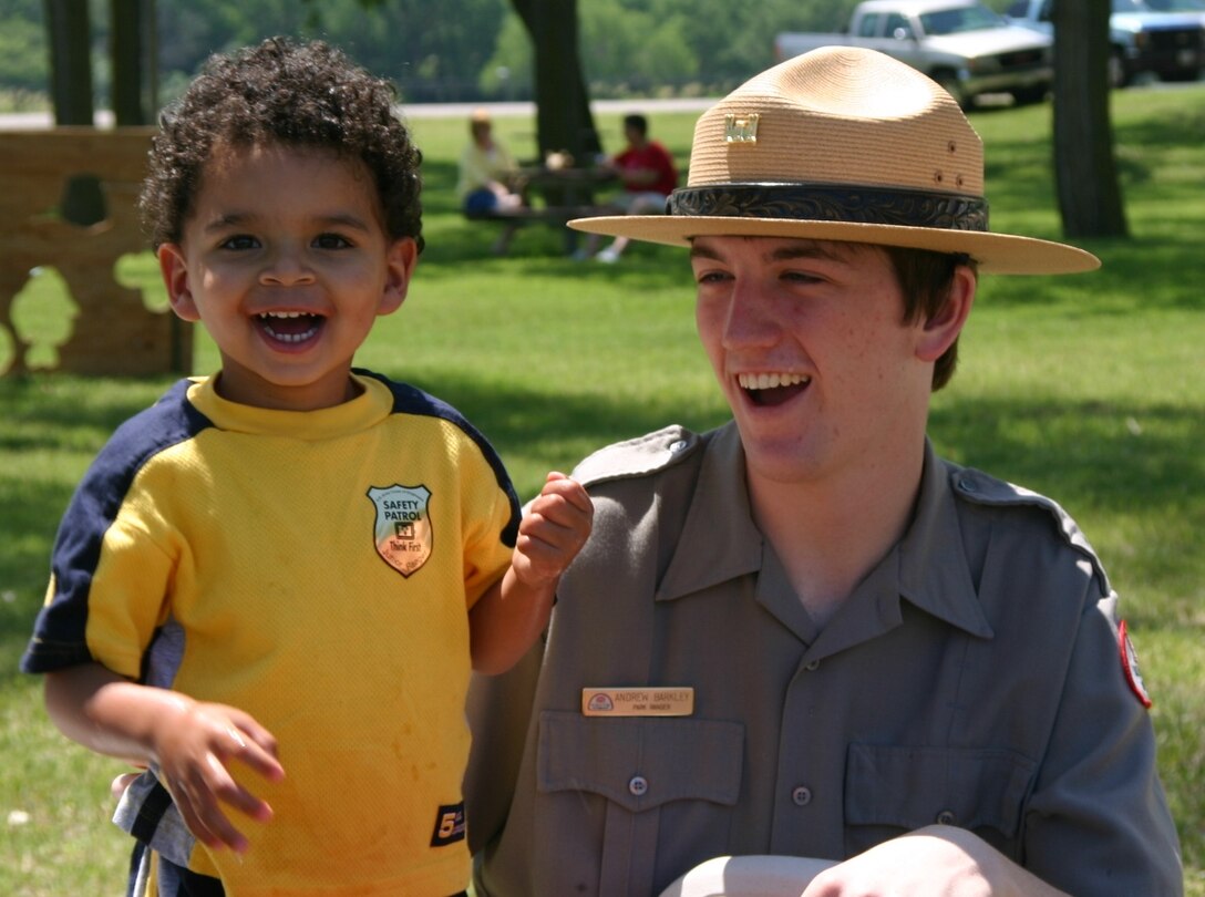 Park Ranger Andy Barkley with a young visitor at a water safety program.