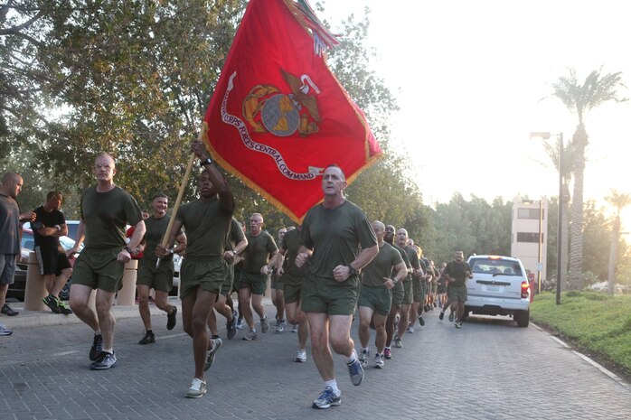 Marine Corps Forces Central Command's Deputy Commanding General, BGen. Gregg P. Olson and SgtMaj. John J. McGovern flank the Colors while leading Marines on a run through the streets of Naval Support Activity, Bahrain Nov. 8 in honor of the Corps' 237th Birthday.