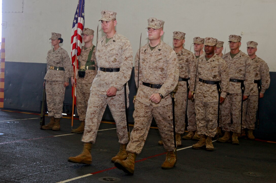 Gunnery Sgts. Vicente Mendez, ammunition chief, Command Element (left,) and Christopher Kluge, Marine Medium Helicopter Squadron 364 (Rein.), both with 15th Marine Expeditionary Unit, march out as part of the sword detail during the 237th Marine Corps Cake Cutting Ceremony held in the hangar bay of the USS Peleliu, Nov. 10. The 15th MEU is deployed as part of the Peleliu Amphibious Ready Group as a theater reserve and crisis response force throughout U.S. Central Command and the U.S. 5th Fleet area of responsibility.
