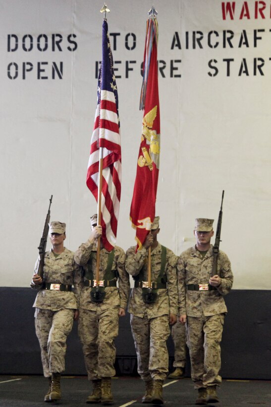 The color guard from Marine Medium Helicopter Squadron 364 (Rein.), 15th Marine Expeditionary Unit, march out before the national anthem was played during the 237th Marine Corps Cake Cutting Ceremony held in the hangar bay of the USS Peleliu, Nov. 10. The 15th MEU is deployed as part of the Peleliu Amphibious Ready Group as a theater reserve and crisis response force throughout U.S. Central Command and the U.S. 5th Fleet area of responsibility.
