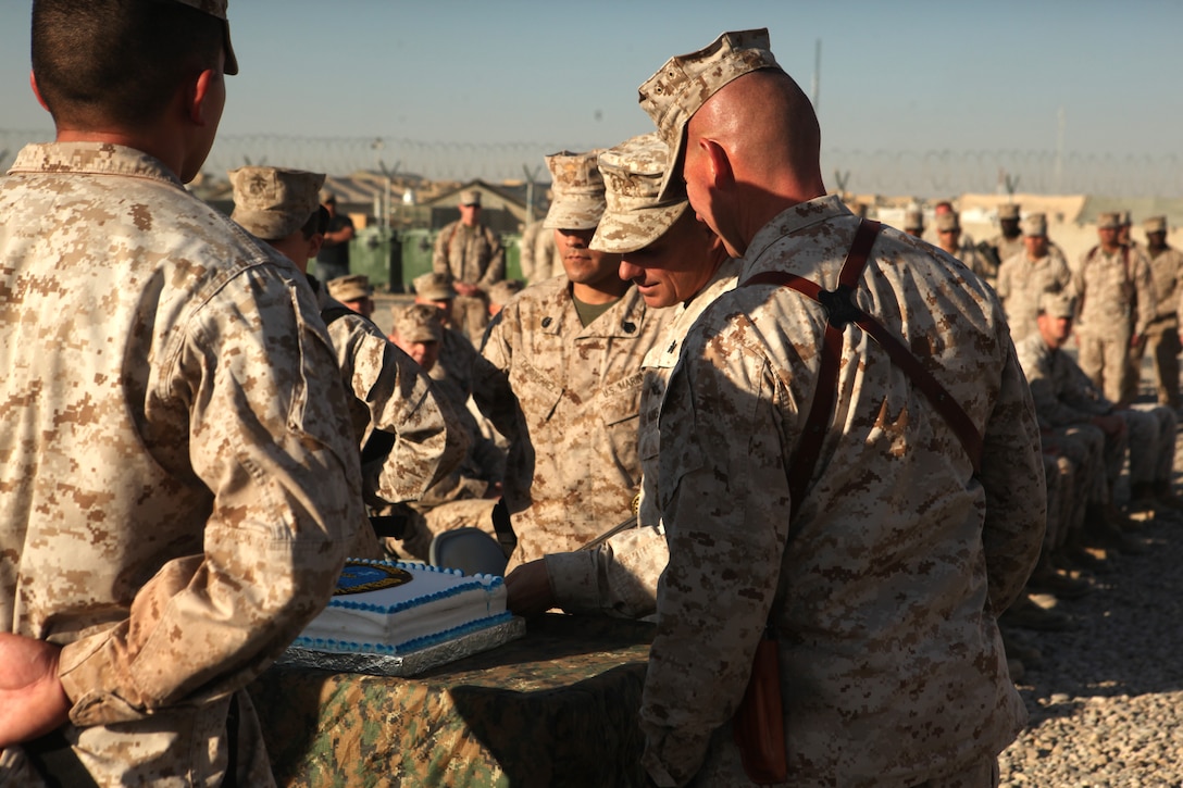 Col. Stephen Sklenka, the commanding officer for Combat Logistics Regiment-15, cuts a piece of birthday cake during a cake cutting ceremony on Camp Leatherneck, Afghanistan, Nov. 10. The piece of cake was given to the oldest Marine present, Maj. Michael Nolan, CLR-15 Logistics Readiness Center officer-in-charge. The piece was then passed to the youngest Marine present, Lance Cpl. Jorden Sexton, a motor vehicle mechanic with Combat Logistics Company-153, signifying the passing of knowledge and tradition from young to old.
