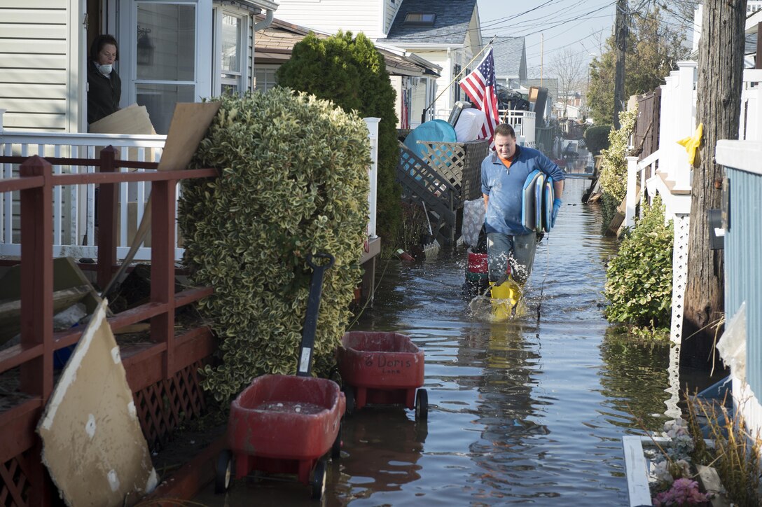 NEW YORK (Nov. 11, 2012) In the wake of Hurricane Sandy residents of Breezy Point, N.Y. clear debris with wagons  Hurricane Sandy was the largest Atlantic hurricane on record and caused the most damage in New York and New Jersey Oct. 29, 2012.  (U.S. Navy photo by Chief Mass Communication Specilalist Ryan J. Courtade/Released)