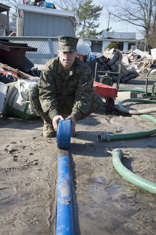 NEW YORK (Nov. 11, 2012) - Marine Private First Class, Daniel Strahl, of Waco, Texas, roles a dewatering hose in Breezy Point, N.Y., a community of less than 5,000 people that was one of the hardest hit during the hurricane. Marines from the 8th Engineering Support Battalion (8th ESB) from Camp Lejeune, N.C. spent Veteran’s Day weekend continuing relief efforts for New York residents impacted by Hurricane Sandy.  Hurricane Sandy was the largest Atlantic hurricane on record and caused the most damage in New York and New Jersey Oct. 29, 2012.  (U.S. Navy photo by Chief Mass Communication Specilalist Ryan J. Courtade/Released)