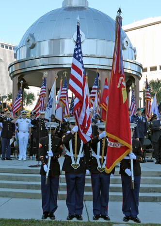 Lieutenant Gen. Robert B. Neller, Commander, US Marine Corps Forces Central Command (MARCENT), presents his battle colors during his Veterans Day speech to the Tampa Bay community, gathered downtown at the Joe Chillura square, to celebrate its veterans and remember those who could not be with us.