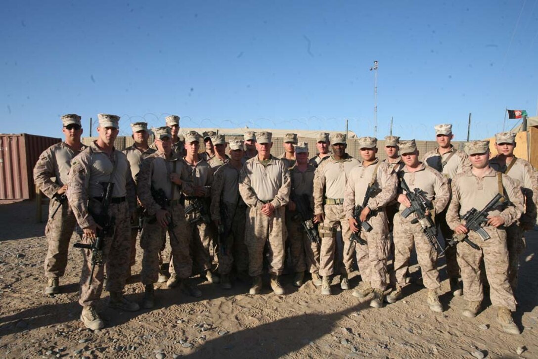 Major Gen. Charles M. Gurganus, Regional Command (Southwest) commanding general, poses for a photograph with Marines at Combat Outpost Rankel, Afghanistan, Nov.10, 2012. Maj. Gen. Gurganus and RC(SW) Sgt. Maj. Harrison Tanksley spent the 237th Marine Corps birthday traveling to  every position in southern Helmand province that had Marines to wish them a happy birthday.