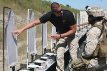 CHESAPEAKE (Sept. 28, 2012) - Sergeant Chad Peters, a close-quarters combat instructor with Training Company, Marine Corps Security Force Regiment provides feedback to Cpl. Yeuris Vicioso, a squad leader with Alpha Company during a live fire exercise aboard Naval Support Activity Hampton Roads, Northwest Annex Sept. 25.
