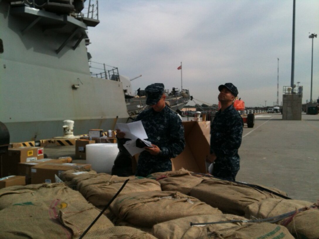 Two sailors with the USS Mahan load supplies into the ship during a training period held for logistics specialists with Medical Logistics Company, 2nd Supply Battalion, 2nd Marine Logistics Group Oct. 14-28, 2012. The training represented a unique opportunity for the company’s sailors to work directly with Navy logistics specialists aboard a ship and experience the specific challenges of resupplying a naval vessel.
