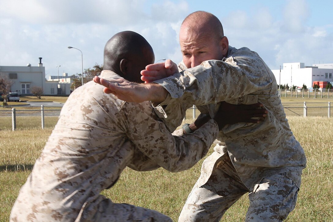 Chief Warrant Officer Rilin P. Desamours and Maj. Robert B. Thomas, right, practice a Marine Corps Martial Arts Program technique during a martial arts instructor course at Camp Kinser Oct. 23. Marines with the Martial Arts Center of Excellence, located at Marine Corps Base Quantico, Va., flew to Okinawa and observed the course and provided some lessons and feedback. Desamours is a tactical communications planning and engineering officer with Headquarters Company, Headquarters Battalion, 3rd Marine Division, III Marine Expeditionary Force. Thomas is the operations officer for Combat Logistics Regiment 37, 3rd Marine Logistics Group, III MEF. 