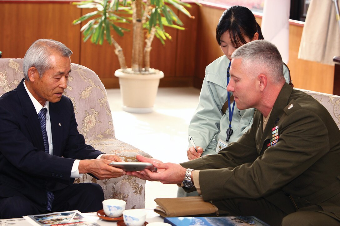 Lt. Col. Jason Brown presents Oshino Village Mayor Yasunori Amano with an ink pen from the National Museum of the Marine Corps as a token of appreciation during a meeting at Amano's office Nov. 9. The meeting gave Brown the opportunity to inform the local mayor about training details and his intent for Artillery Relocation Training Program 12-3. Brown is the commanding officer of 3rd Battalion, 12th Marine Regiment, 3rd Marine Division, III Marine Expeditionary Force. Oshino Village is located in close proximity to the North Fuji Maneuver Area, where ARTP 12-3 is being conducted. 
