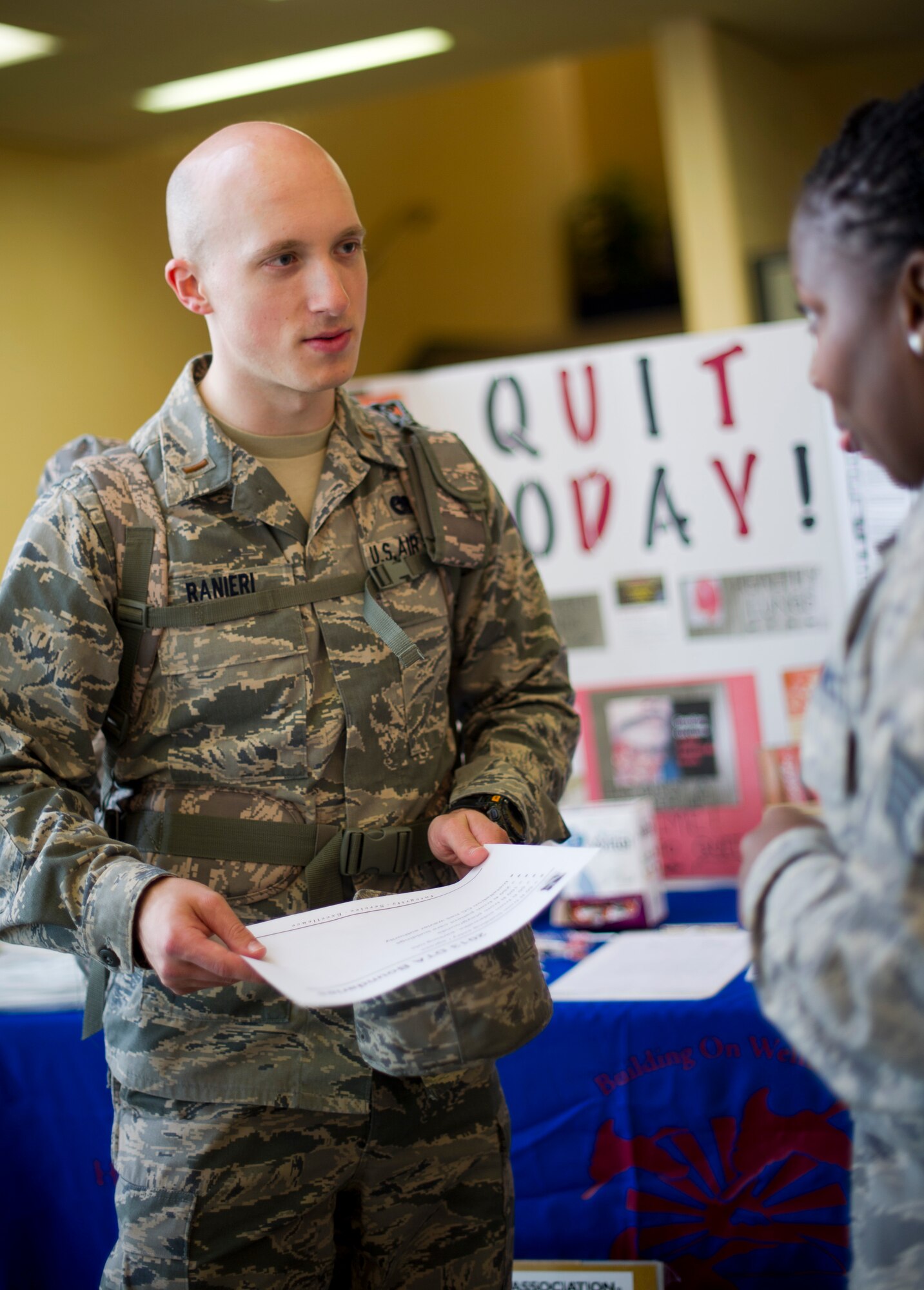 YOKOTA AIR BASE, Japan -- 2nd Lt. Luke Ranier, 730th Air Mobility Squadron talks with Staff Sgt. Treshawna Gwendo, Health and Wellness Center NCO in charge during the Great American Smokeout event Oct. 15, 2012 at Yokota Air Base, Japan. The event is held to educate the base on smoking and its negative health effects as well as giving smokers a chance to sign a pledge to quit. (U.S. Air Force photo by Staff Sgt Stacy Moless)
