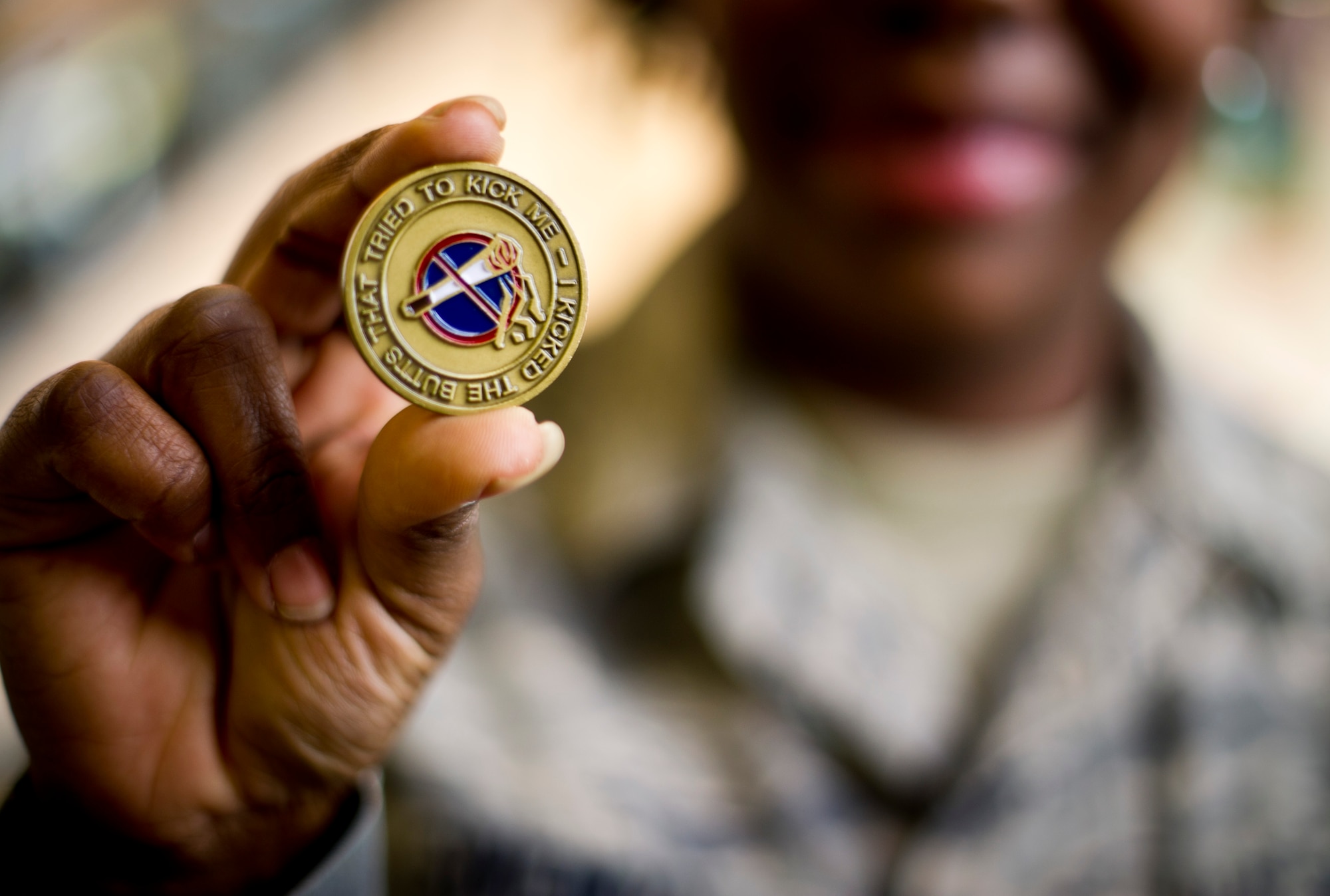 YOKOTA AIR BASE, Japan -- Staff Sgt. Treshawna Gwendo, Health and Wellness Center NCO in charge holds up a coin she will give to anyone who chooses to stop smoking today during the Great American Smokeout event Oct. 15, 2012 at Yokota Air Base, Japan. This year, 374th Medical Group hosted The Great American Smokeout outside the Yokota Community Center to support and educate the base regarding smoking and its negative health effects. (U.S. Air Force photo by Staff Sgt Stacy Moless) 