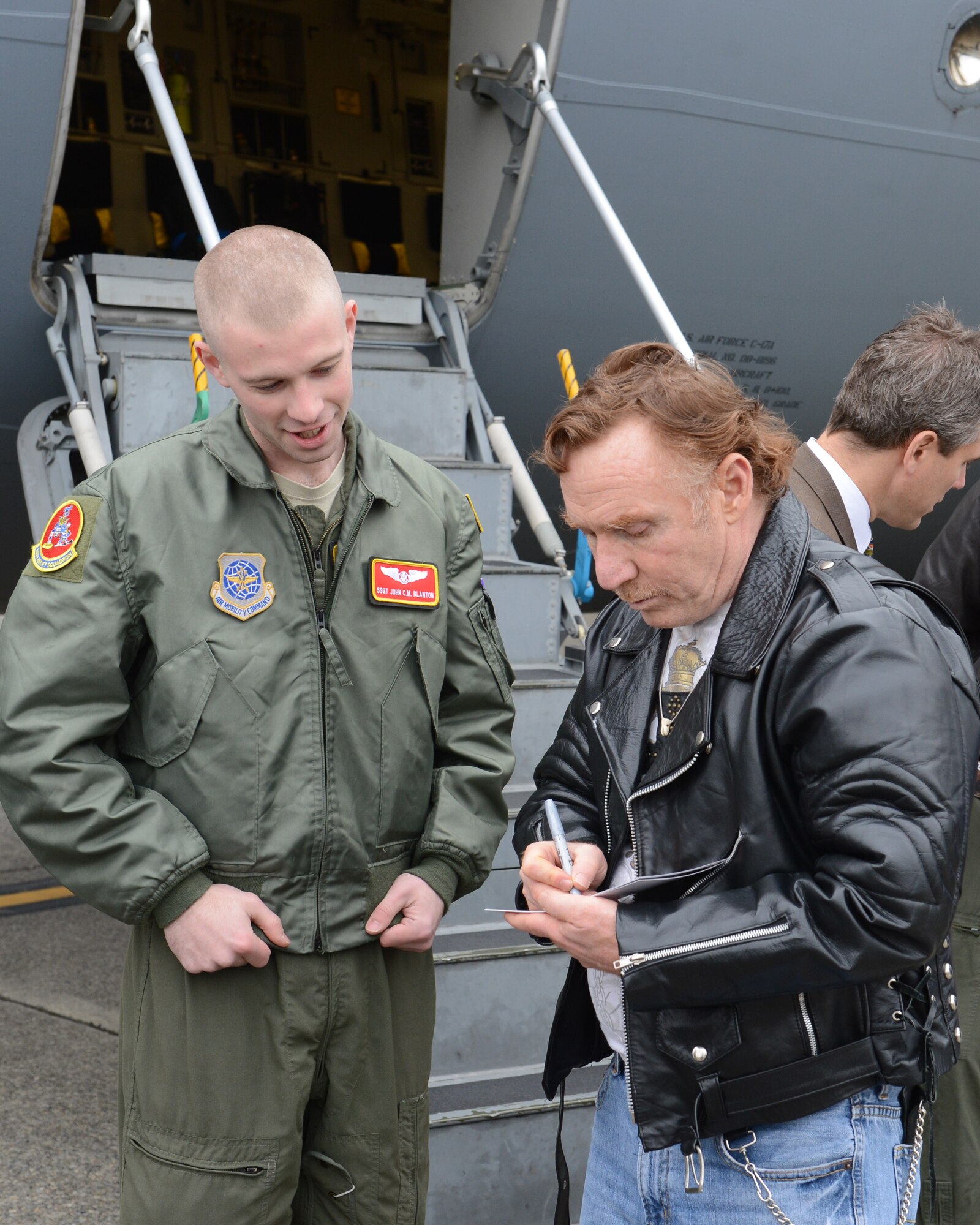 Danny Bonaduce (right), local radio host for KZOK channel 102.5 FM and former child actor, signs a photo for Staff Sgt. John Blanton, 10th Airlift Squadron loadmaster, Nov. 15, 2012 at Joint Base Lewis-McChord, Wash. Bonaduce toured several places on McChord Field including the McChord Field control tower, a C-17 Globemaster III static display and the JBLM USO Northwest Shali Center. (U.S. Air Force photo/Staff Sgt. Sean Tobin)