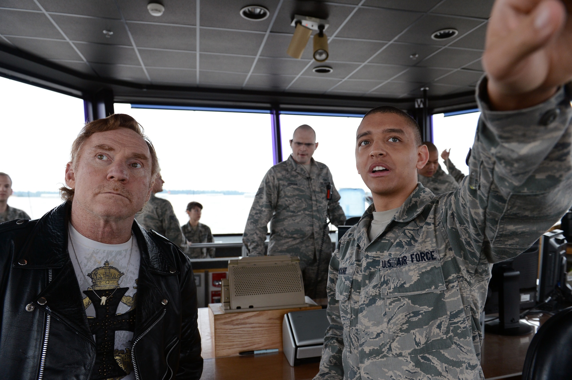 Danny Bonaduce (right), local radio host for KZOK channel 102.5 FM and former child actor, along with Airman 1st Class Alvin Moore, 62nd Operations Support Squadron air traffic controller, watch a C-17 Globemaster III aircraft take-off , Nov. 15, 2012 at Joint Base Lewis-McChord, Wash. Bonaduce visited McChord Field as part of a USO morale visit. (U.S. Air Force photo/Staff Sgt. Sean Tobin)