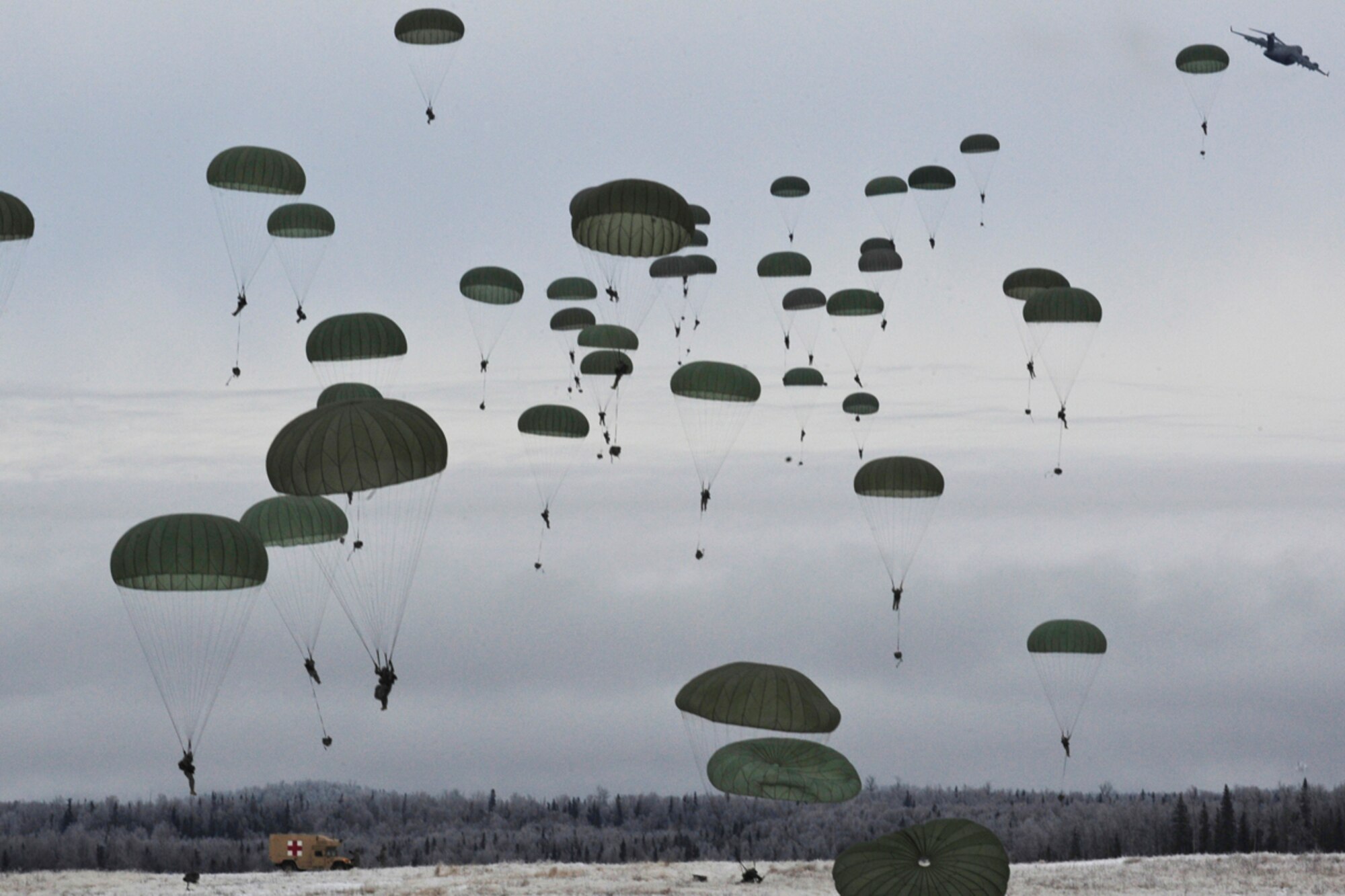 JOINT BASE ELMENDORF-RICHARDSON, Alaska -- Paratroopers of U.S. Army Alaska's 4th Brigade Combat Team (Airborne), 25th Infantry Division conduct a training parachute assault on Malamute Drop Zone on Joint Base Elmendorf-Richardson, Tuesday, Nov. 13, 2012.  The brigade recently returned from a ten-month tour in Afghanistan, and approximately 200 of the unit's Soldiers made the jump into their sub-arctic home installation. (U.S. Air Force photo by Justin Connaher)
