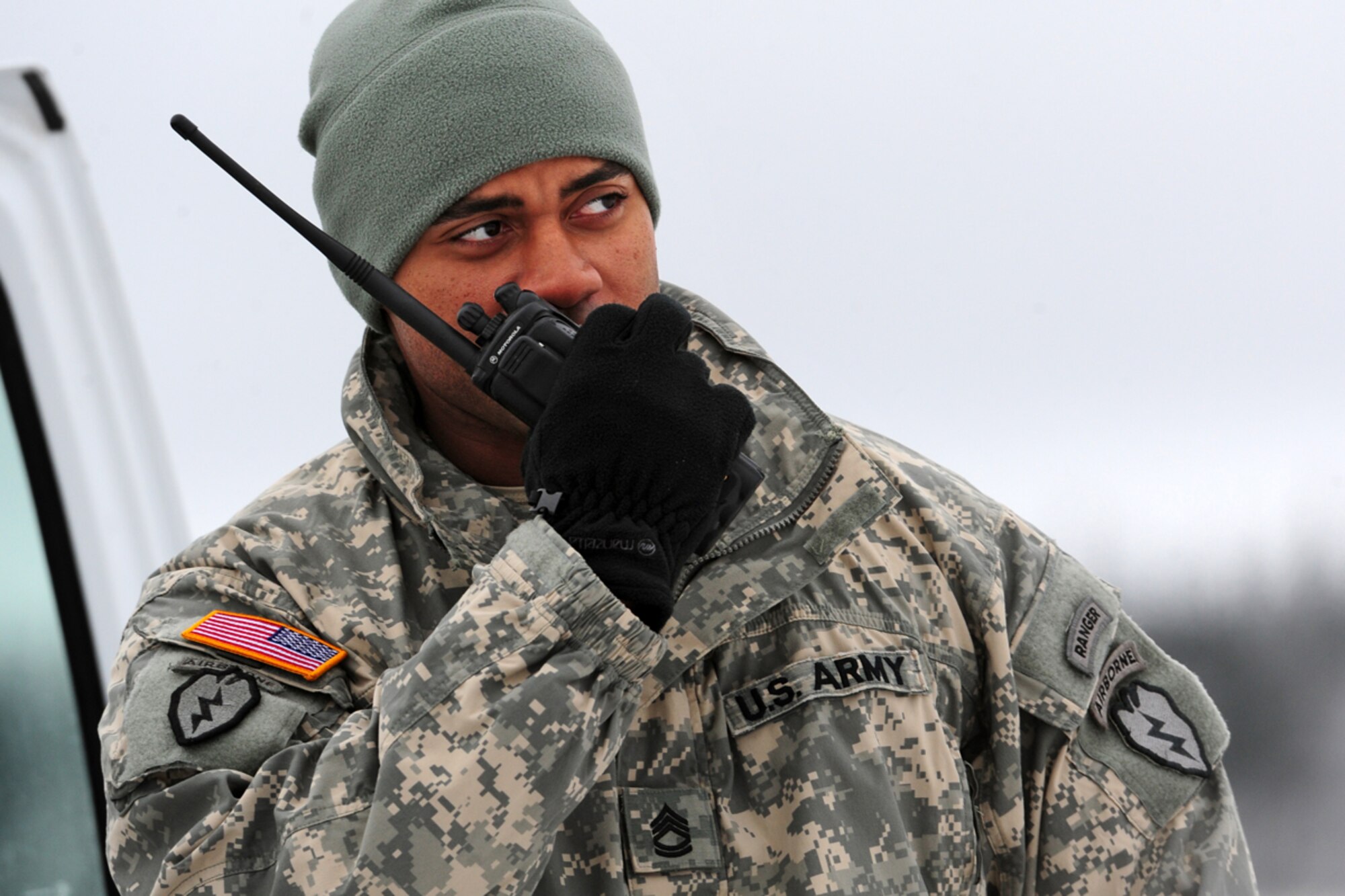 JOINT BASE ELMENDORF-RICHARDSON, Alaska -- Sgt. 1st Class Jovanny Jones, Apache Troop 1st Squadron (Airborne) 40th Cavalry Regiment, makes a call over a radio on Malemute Drop Zone before paratroopers of U.S. Army Alaska's 4th Brigade Combat Team (Airborne), 25th Infantry Division conduct a training parachute assault on Joint Base Elmendorf-Richardson, Tuesday, Nov. 13, 2012.  The brigade recently returned from a ten-month tour in Afghanistan, and approximately 200 of the unit's Soldiers made the jump into their sub-arctic home installation. (U.S. Air Force photo by Justin Connaher)