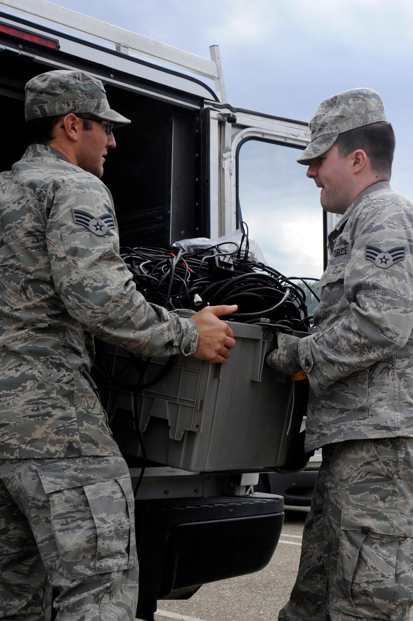 VANDENBERG AIR FORCE BASE, Calif. -- Senior Airman Robert Lonack and Senior Airman Vance Hanson, 30th Space Communications Squadron members, unload a container of electronic cords and cables for disposal during a collection event Thursday, Nov 15., 2012. Over 80 Team Vandenberg members dropped off their electronic waste during this event which occurs twice annually in conjunction with both Earth Day and America Recycles Day. (U.S. Air Force photo/Michael Peterson)