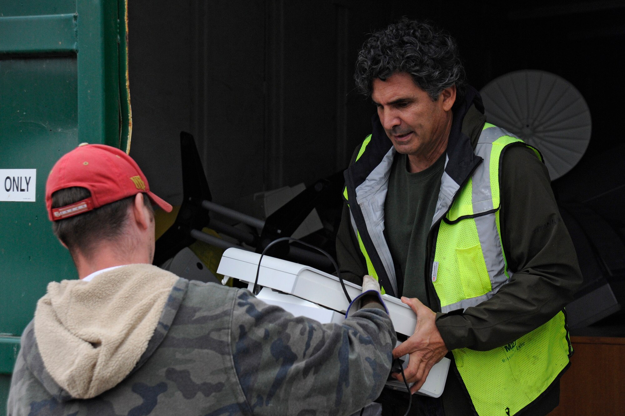 VANDENBERG AIR FORCE BASE, Calif. -- Chris Hopkins, a Marshallia Ranch golf maintenance worker, turns in old electronic equipment to Michael Labarbera, a Waste Management official, during an E-waste collection event at Vandenberg Thursday, Nov. 15, 2012. Over 80 people dropped off their e-waste during this event which occurs twice annually in conjunction with both Earth Day and America Recycles Day. (U.S. Air Force photo/Michael Peterson)