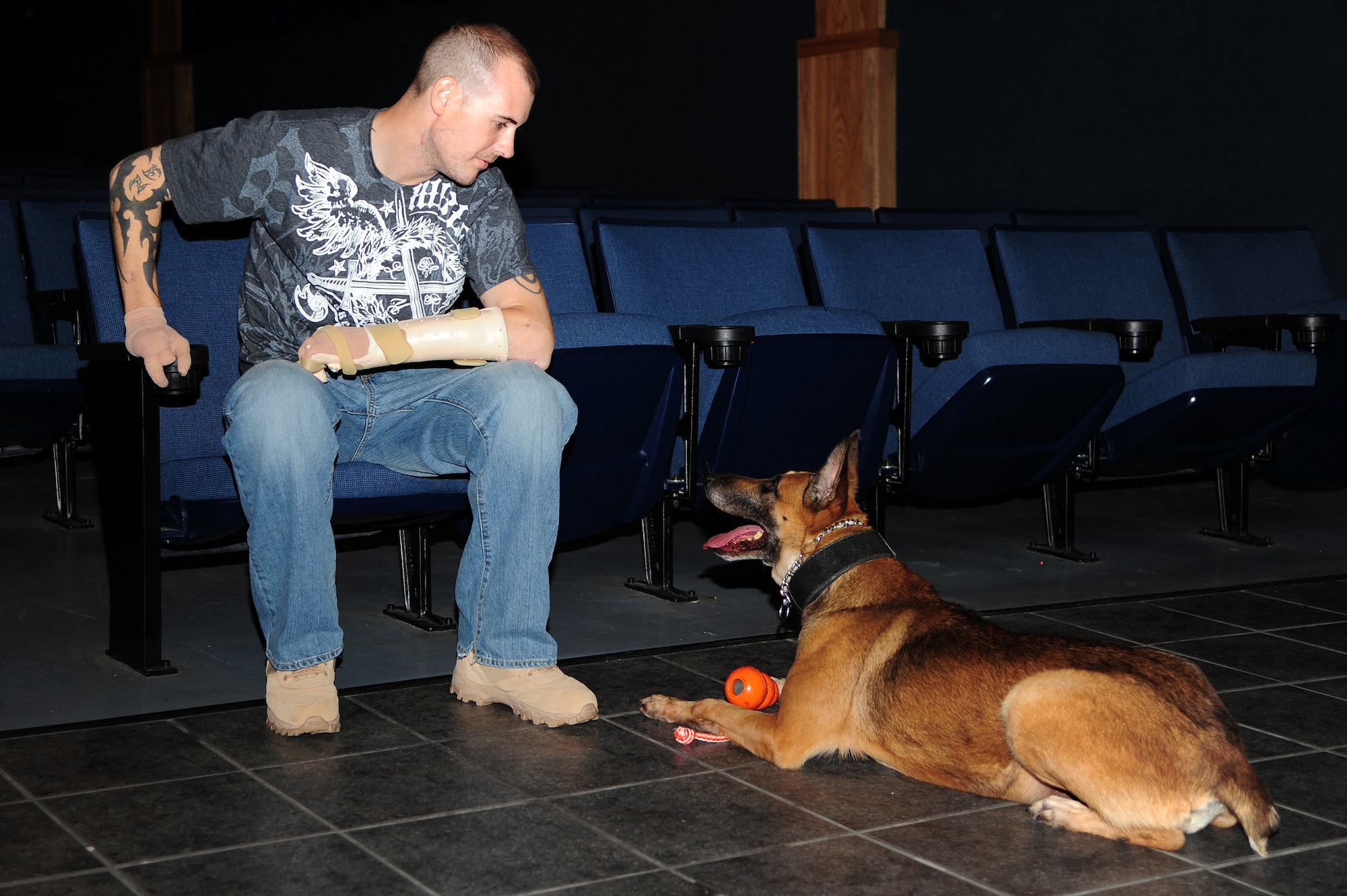Staff Sgt. Leonard Anderson, 59th Patient Squadron, Lackland Air Force Base, Texas, talks to Azza, 354th Security Forces Squadron military working dog, at the base theater Oct. 17, 2012, Eielson Air Force Base, Alaska. Anderson worked with Azza, an 8-year-old Belgian Malinois, for over a year while he was assigned to the 354th SFS MWD section. (U.S. Air Force photo/Airman 1st Class Zachary Perras)