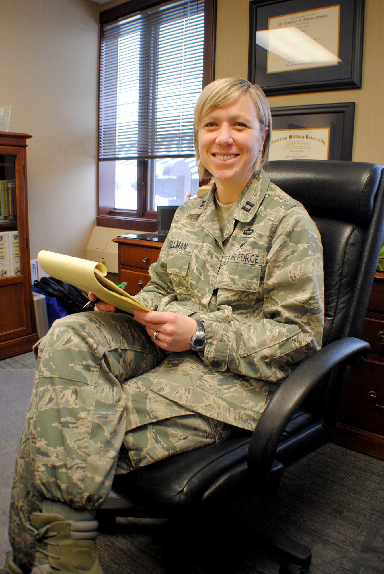 Capt. Taren Wellman, chief of adverse actions at the 319th Air Base Wing legal office, pauses for a moment after reviewing notes to smile for a photo taken inside her office at the base legal office Mar. 2, 2012, on Grand Forks Air Force Base, N.D. Wellman became the Air Mobility Command’s first officer to be nominated for the Brig. Gen. Wilma Vaught Visionary Leadership Award. (U.S. Air Force graphic/Senior Airman Luis Loza Gutierrez)