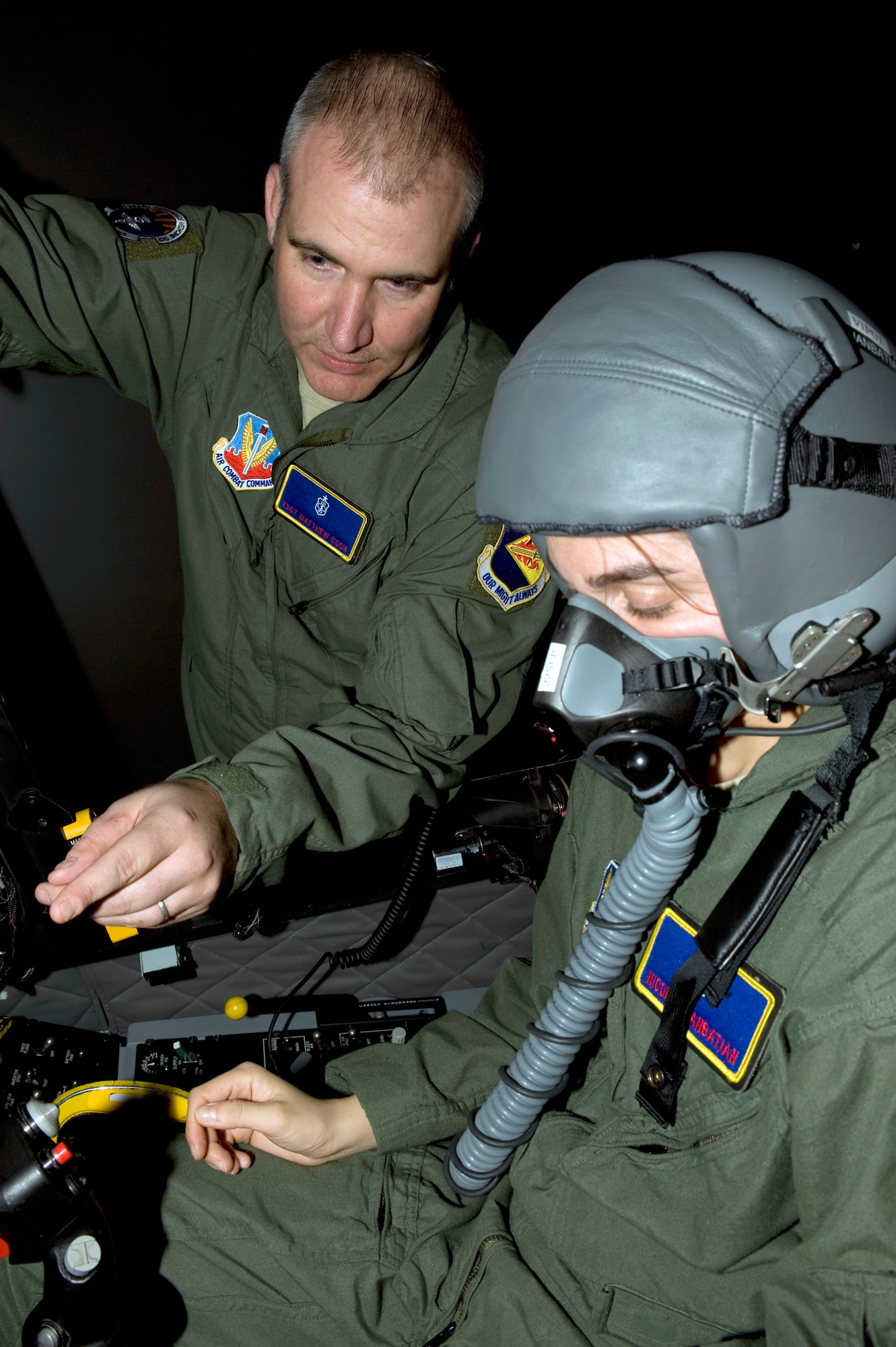 U.S. Air Force Tech. Sgt. Matthew Cook explains a training profile to Capt. Nicole Djanbatian, both from the 355th Aerospace Medicine Squadron, in an A-10 Thunderbolt simulator on Davis-Monthan Air Force Base, Ariz., Nov. 7, 2012. Sergeant Cook explained what Capt. Djanbatian would be doing at the beginning of the profile and reminded her of the hypoxia corrective procedures. (U.S. Air Force photo by Senior Airman Timothy Moore/Released)