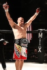 Tech Sgt. Angelo Gutierrez, Air Education and Training Command NCO in charge of personal security, celebrates his victory wearing the heavyweight championship belt after defeating Cameron Martin in an MMA Premier Combat Group bout Jan. 28 at Cowboys Dance Hall. (Courtesy photo)