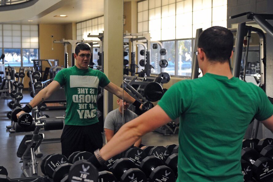 An Airman from the 2nd Security Forces Squadron lifts weights at the Fitness Center on Barksdale Air Force Base, La., Nov. 15. The Fitness Center is open from 4 a.m. to midnight on weekdays and 8 a.m. to 6 p.m. on weekends.  Approximately 8,000 Airmen, dependents and retirees use the facility each week. (U.S. Air Force photo/Senior Airman Micaiah Anthony)(RELEASED)
