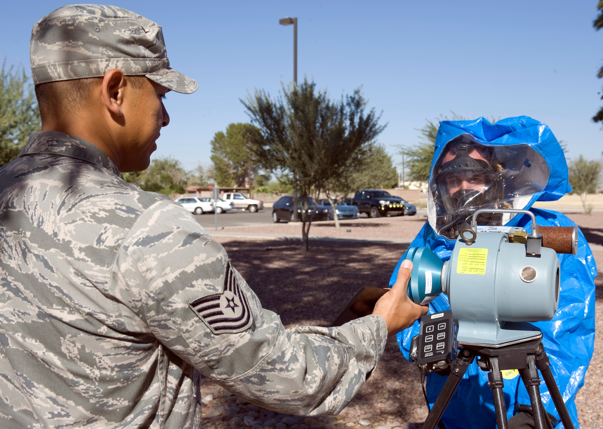 U.S. Air Force Tech. Sgt. Anthony Maez inspects the data collection method of Airman 1st Class Andres Escobar, both bioenvironmental engineering technicians with the 355th Aerospace Medicine Squadron, using a radeco air sampler on Davis-Monthan Air Force Base, Ariz., Nov. 7, 2012. The radeco air sampler measures the radiation level in the surrounding air. Bioenvironmental engineering technicians use the measurements to determine if an area is safe for personnel to enter. (U.S. Air Force photo by Senior Airman Timothy Moore/Released)
