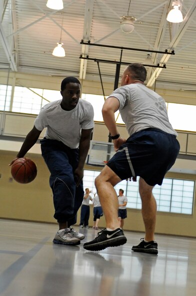 Airmen from the 2nd Comptroller Squadron play basketball in the Fitness Center on Barksdale Air Force Base, La., Nov. 15. Many units around base meet at the gym for physical training. The Fitness Center offers a variety of sports for Airmen to play such as football, softball, dodgeball, walleyball, basketball, racquetball, kickball and volleyball. (U.S. Air Force photo/Senior Airman Micaiah Anthony)(RELEASED)
