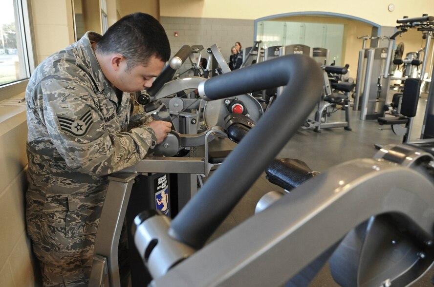 Staff Sgt. Tommie Andres, 2nd Force Support Squadron fitness specialist, inspects an exercise machine on Barksdale Air Force Base, La., Nov. 15. Fitness equipment is checked every day to ensure proper functionality. (U.S. Air Force photo/Senior Airman Micaiah Anthony)(RELEASED)