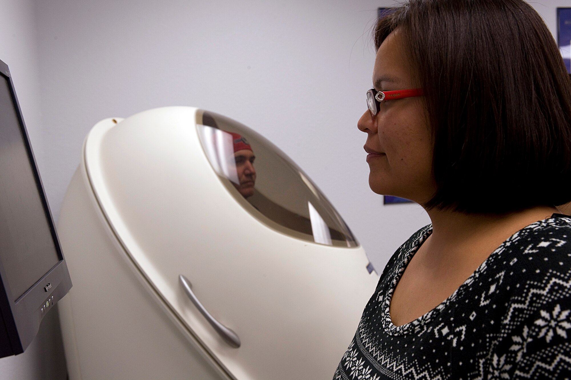 Lana Fred, 355th Aerospace Medicine Squadron health educator, monitors a Bod Pod measurement on Davis-Monthan Air Force Base, Ariz., Nov. 6, 2012. The Bod Pod calculates a person's body composition and gives them a body fat rating as well as an estimated resting metabolic rate for a day's time. (U.S. Air Force photo by Senior Airman Timothy Moore/Released)