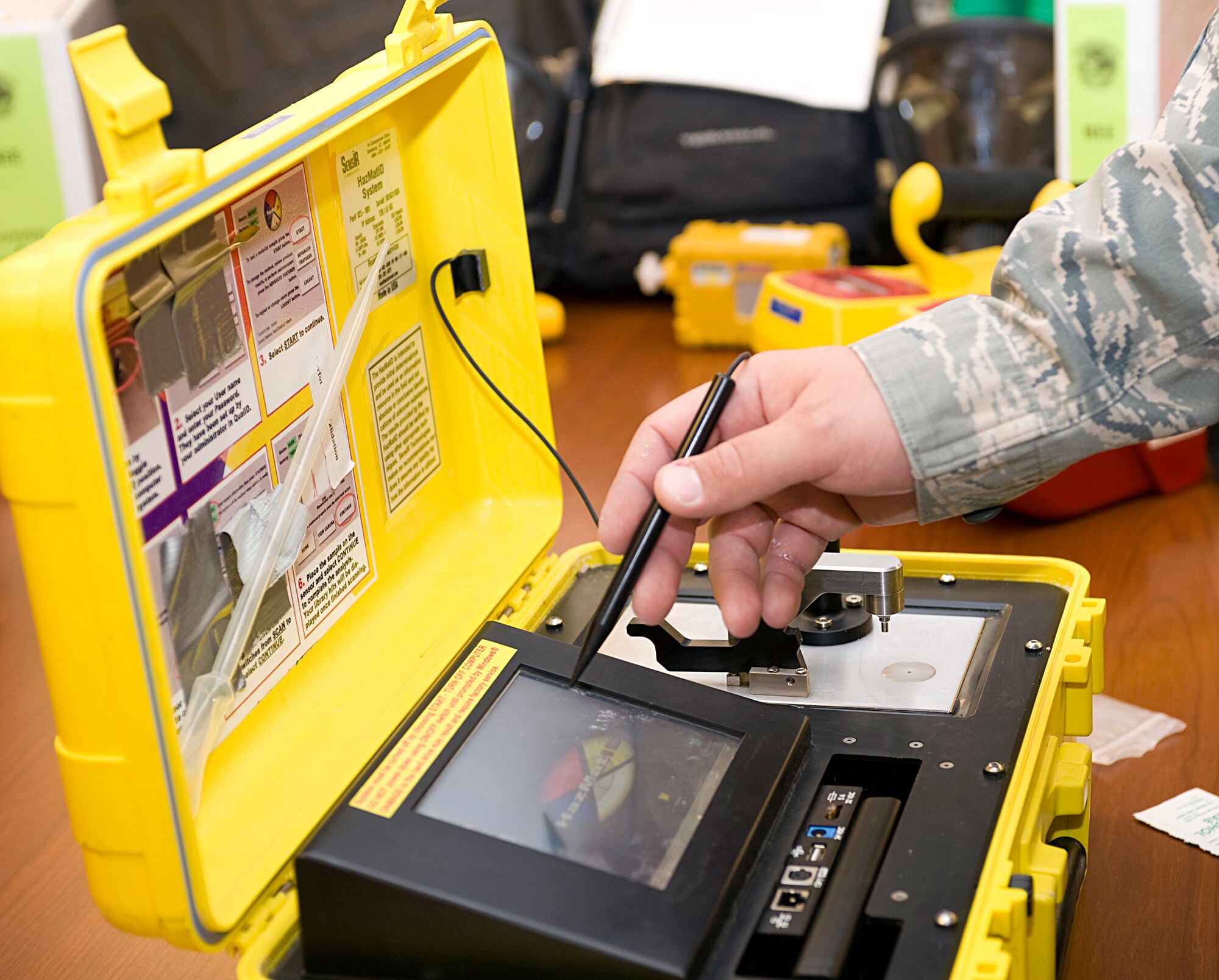 U.S. Air Force Staff Sgt. John Slavonik, 355th Aerospace Medicine Squadron bioenvironmental engineering technician, performs an operations check on a hazardous material identifier on Davis-Monthan Air Force Base, Ariz., Nov. 6, 2012. The machine is used to identify possible hazardous substances in certain materials and liquids. (U.S. Air Force photo by Senior Airman Timothy Moore/Released)