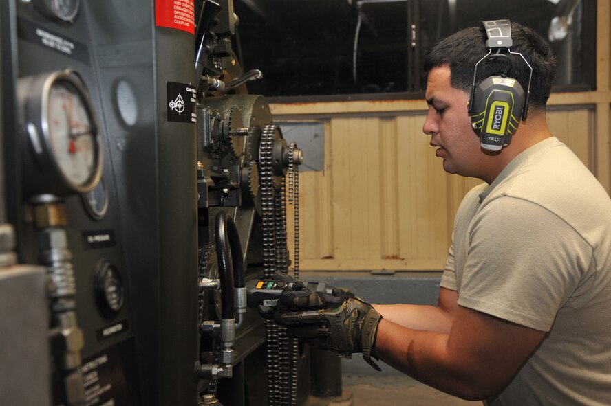Senior Airman Michael Pauley, 56th CES electric power production technician, holds a tachometer during synchronization on a barrier arresting kit on the Luke Air Force Base flightline. (U.S. Air Force photo Senior Airman Sandra Welch)