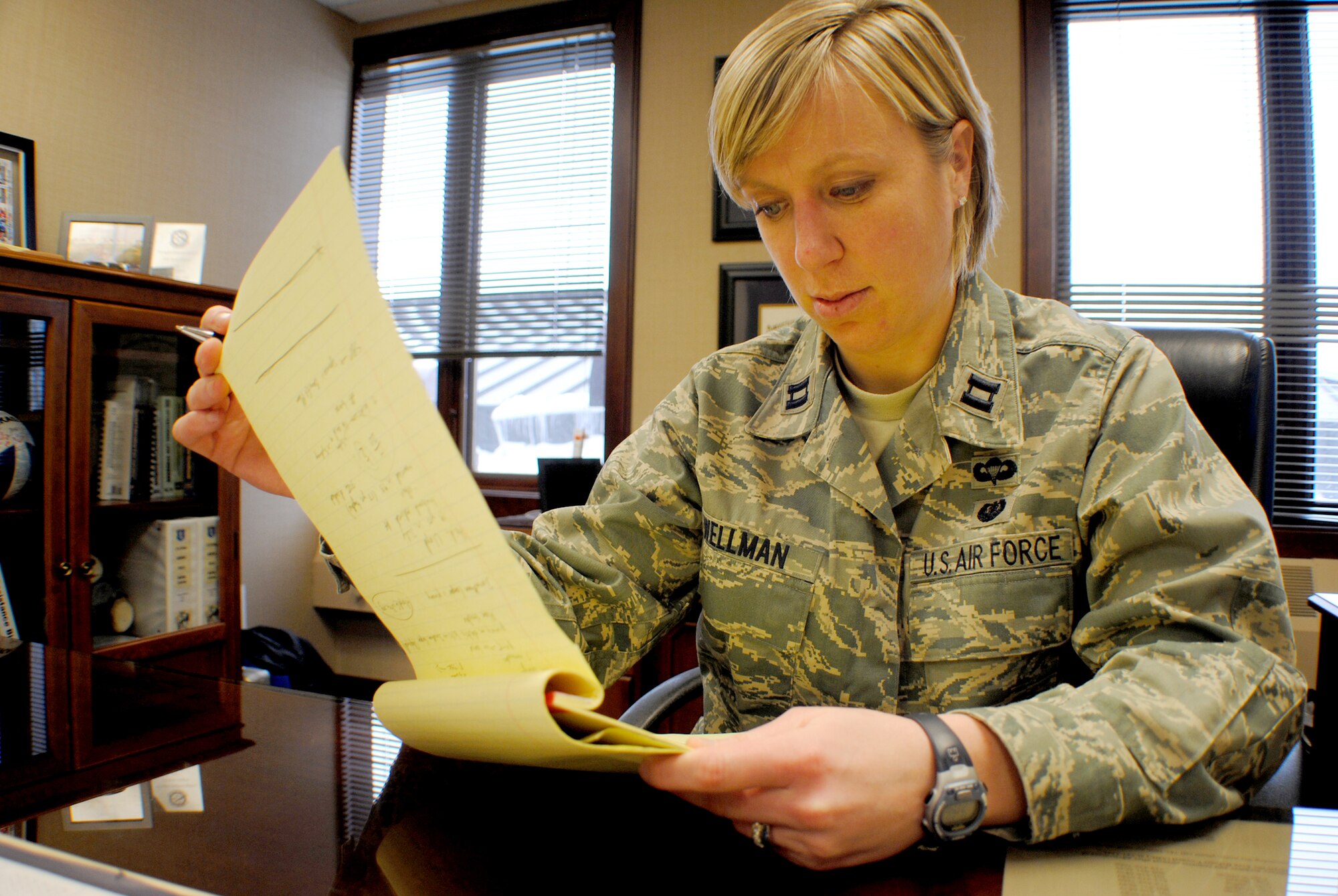 Capt. Taren Wellman, chief of adverse actions at the 319th Air Base Wing legal office, reviews notes from a staff meeting at her office Mar. 2, 2012,  on Grand Forks Air Force Base, N.D. Wellman became the Air Mobility Command’s first officer to be nominated for the Brig. Gen. Wilma Vaught Visionary Leadership Award. (U.S. Air Force graphic/Senior Airman Luis Loza Gutierrez)