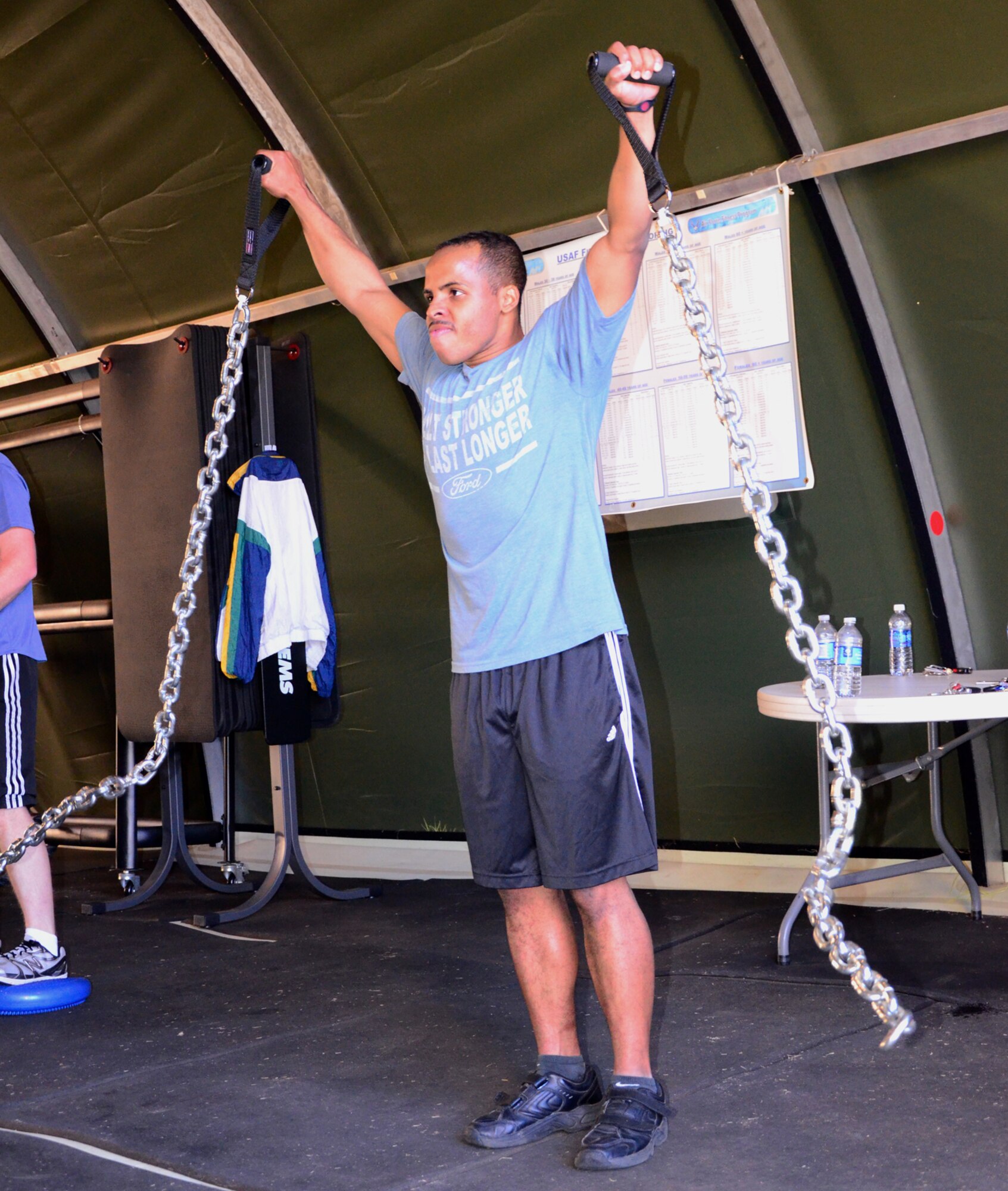 John Mikula, Dobbins exercise physiologist, instructs a fitness class and uses the Total Body Resistance Exercise, or TRX, Suspension Training,with endarance training. Mikula offers his strength and conditioning classes for Dobbins members three times a week, on Mondays, Wednesdays and Fridays at 9 a.m. (U.S. Air Force photo/Senior Airman Elizabeth Van Patten)