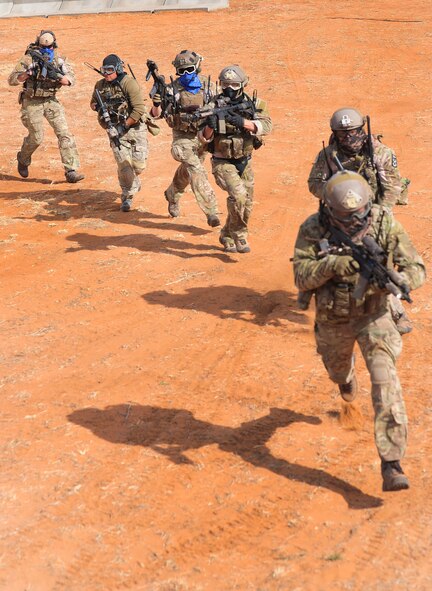 A group of special forces unit members rush into action during an exercise at Melrose Air Force Range, N.M., Nov. 8, 2012. The range is one of Air Force Special Operations Command’s premiere training facilities and is utilized by multiple agencies and branches of the armed forces. (U.S.  Air Force photo/Airman 1st Class Ericka Engblom)