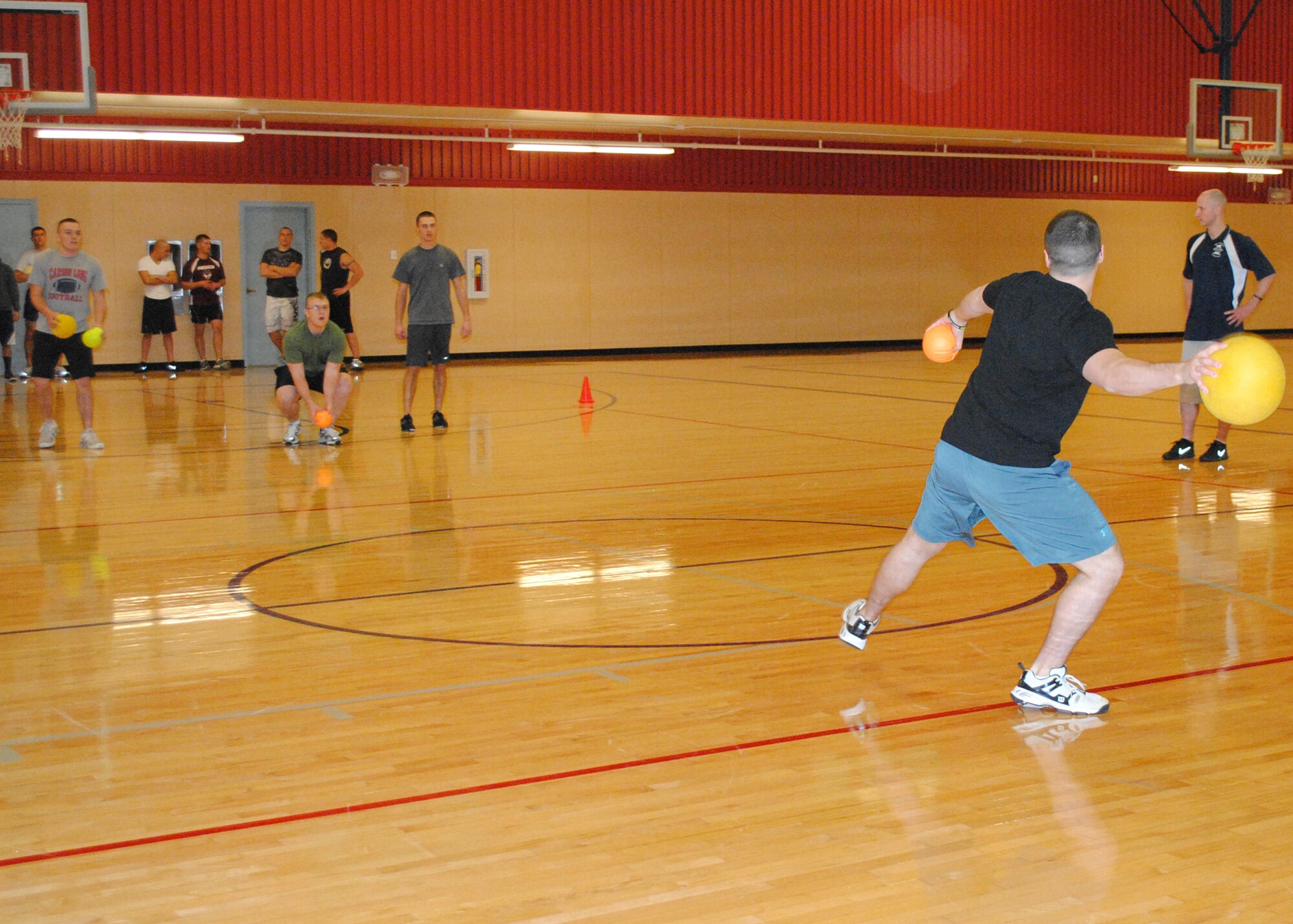 Airman 1st Class Adam Roberts, 341st Logistics Readiness Squadron traffic management apprentice, throws a ball at members of the 341st Munitions Squadron team during a dodge ball tournament at the Fitness Center on Nov. 9. The event kicked off Operation Holiday Cheer, a five-week competition for all Department of Defense ID card holders at Malmstrom who are 18 years or older. The next event is a 3-on-3 soccer tournament scheduled for today at the Fitness Center indoor soccer field at 5 p.m., followed by a 9-pin no tap bowling tournament on Nov. 30  from 5 to 8 p.m. For more information or to sign up, go to www.341fss.com. (U.S. Air Force photo/Airman 1st Class Katrina Heikkinen)
