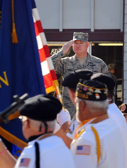 U.S. Air Force Chief Master Sgt. William W. Thomaston, 55th Wing command chief, salutes the stars and stripes while attending the annual Veterans Day Parade in Bellevue, Neb., Nov. 10.  Leadership from the Team Offutt stood on the grandstand as the parade marched by.  (U.S. Air Force photo by Josh Plueger/Released)