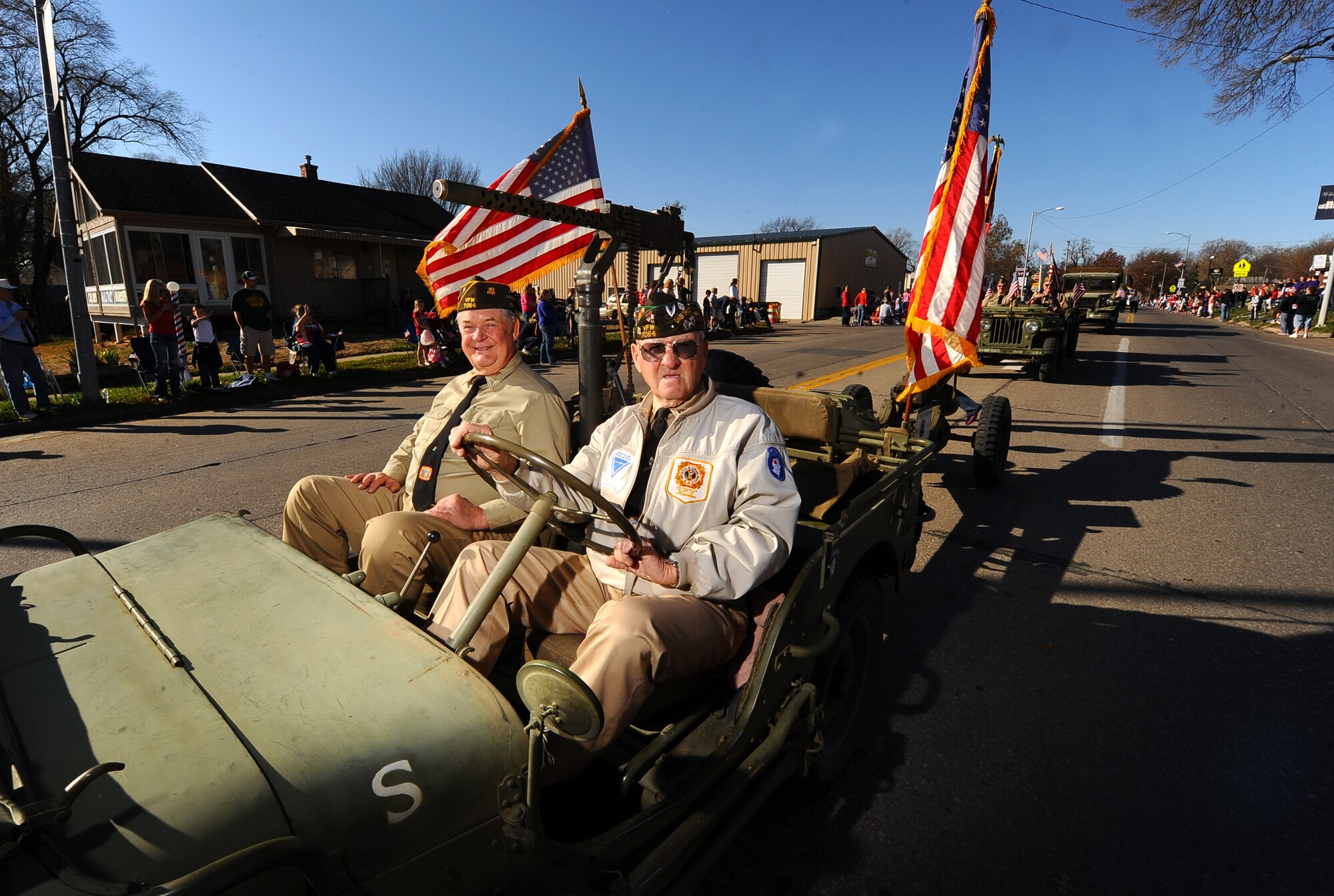 The Veterans of Foreign War Post 7064 of Tabor, Iowa, convoy through Olde Towne Bellevue as part of the Veterans Day Parade in Bellevue, Neb., Nov. 10.  A proud military heritage was on display as veterans both young and old had a chance to march in the parade.  (U.S. Air Force photo by Josh Plueger/Released)