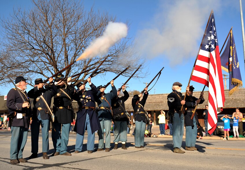 The 1st Nebraska Volunteer Infantry fires a round in the sky at the 2012 Veterans Day parade in Bellevue, Neb. Nov. 10. There were more than 80 entries in this year’s parade. (U.S. Air Force photo by Jeff W. Gates/Released)