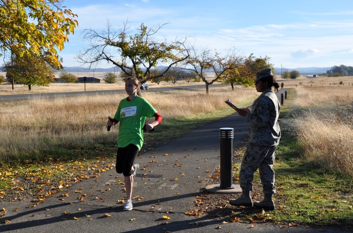 Jessica Clayton, a member of Team Beale, finishes the Turkey Trot 5K at Beale Air Force Base, Calif., Nov. 14, 2012. Clayton took first place with a time of 18:37. (U.S. Air Force photo by Staff Sgt. Robert M. Trujillo/Released)