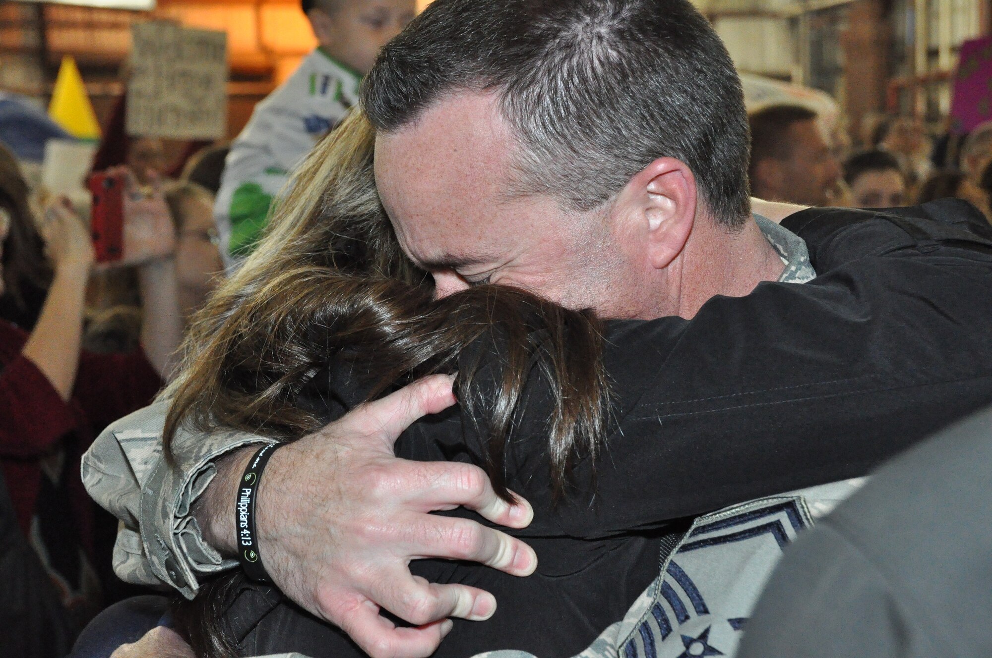 Senior Master Sgt. Mike Gibson, an Air Surveillance Technician assigned to the 970th Airborne Air Control Squadron, hugs his wife, Shawna. Eighty nine reservists returned Sunday night from a 6-month activation supporting Operation Enduring Freedom in Southwest Asia. (U.S. Air Force Photo by Tech. Sgt. Sandra Hatton)