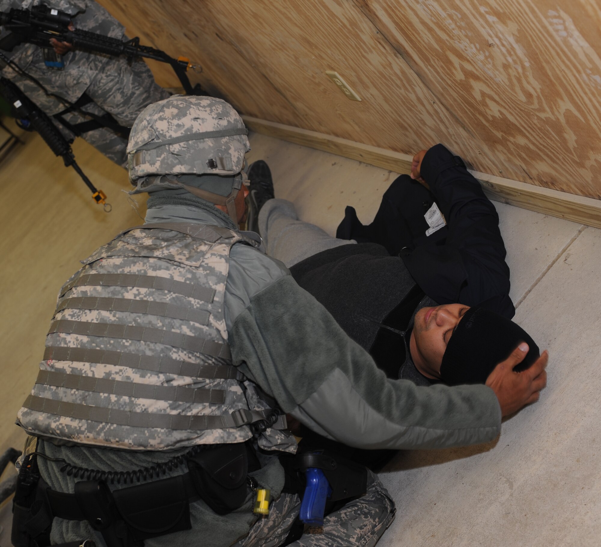 U.S. Air Force Staff Sgt. Ervin Faison, 633rd Security Forces Squadron emergency control center operator, searches Master Sgt. Scott Wagonblott, simulation shooter, for additional weapons and identification during an active shooter exercise at Langley Air Force Base, Va., Nov. 15, 2012. The exercise tested participants’ ability to address communications and response procedures between first responders and base command and control. (U.S. Air Force photo by Airman 1st Class Teresa Aber/Released)