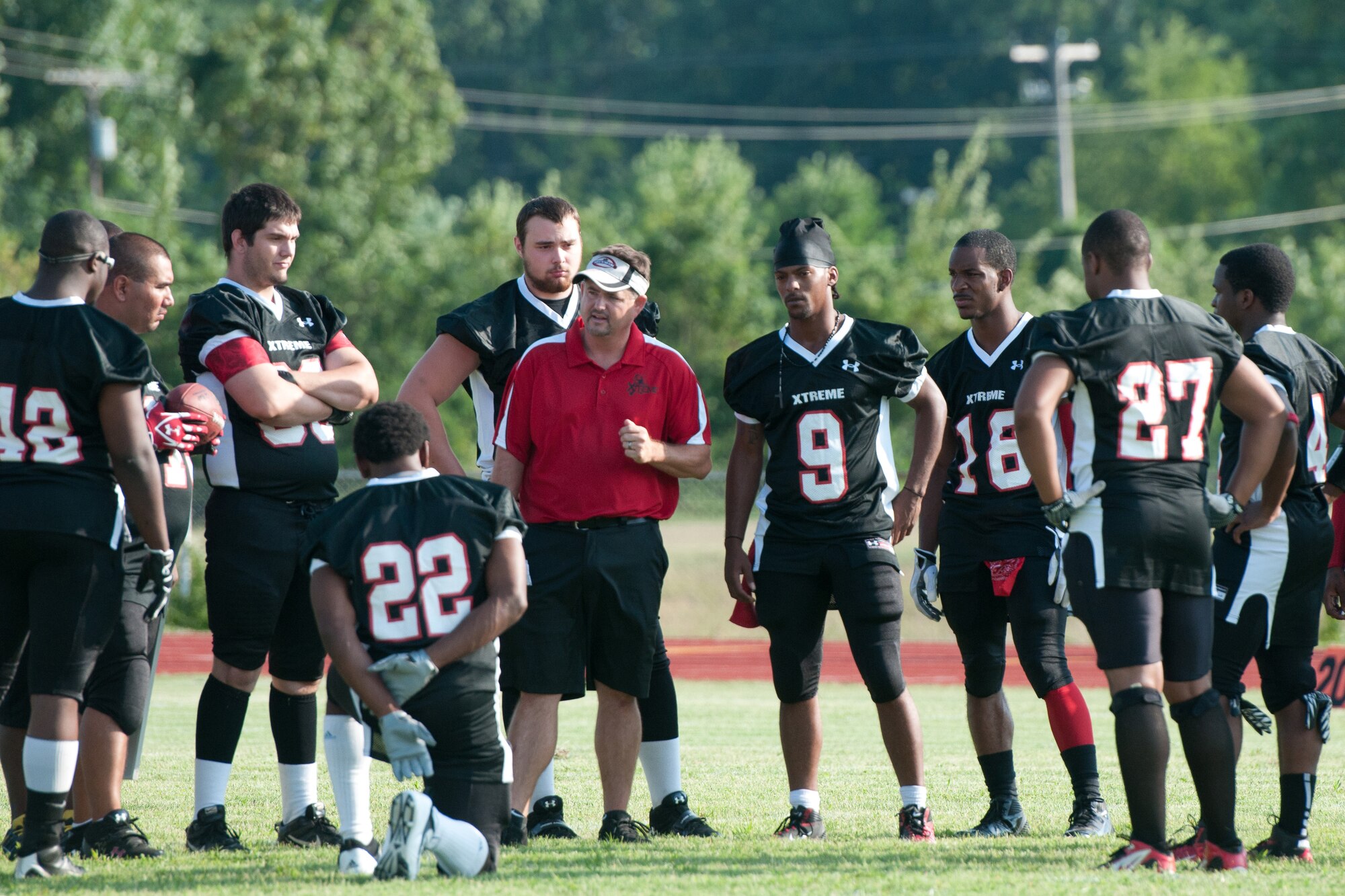 Dave Rooney, head offensive coordinator for the Kentucky Xtreme football team, discusses plays during a football game in Jeffersonville, Ind., on July 28, 2012. Rooney is the Airmen and Family Readiness Program manager for the Kentucky Air National Guard???s 123rd Airlift Wing in Louisville, Ky. (Kentucky Air National Guard photo by Master Sgt. Phil Speck)